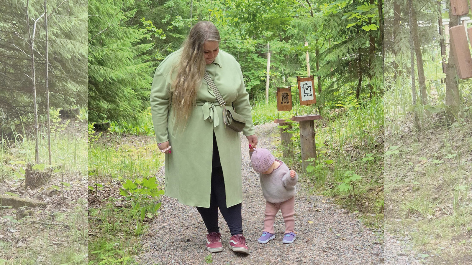 Äiti ja lapsi kävelevät käsikkäin metsäpolulla