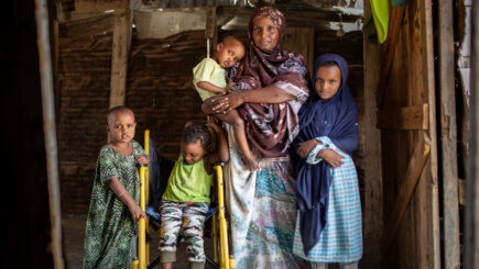 Somalimaa. Kuvassa perhe, jossa sisätiloissa äiti lapsineen poseeraa seisten.