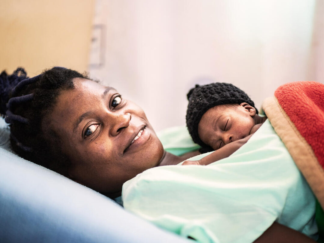 Lilian, 32, holding her newborn baby in the Kangaroo Mothercare ward at a hospital in Bungoma, Kenya.