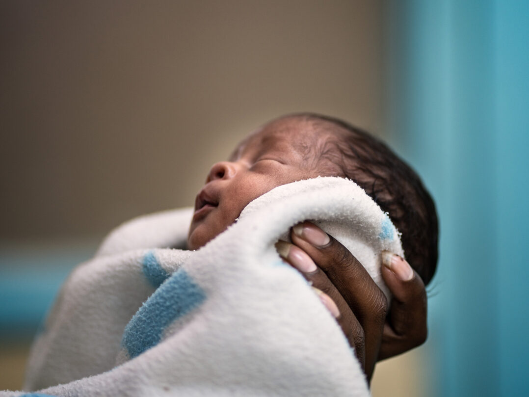 Fatuma, 21, holding her new born baby Nathan in the Kangaroo Mother Care ward at a hospital in Bungoma, Kenya.