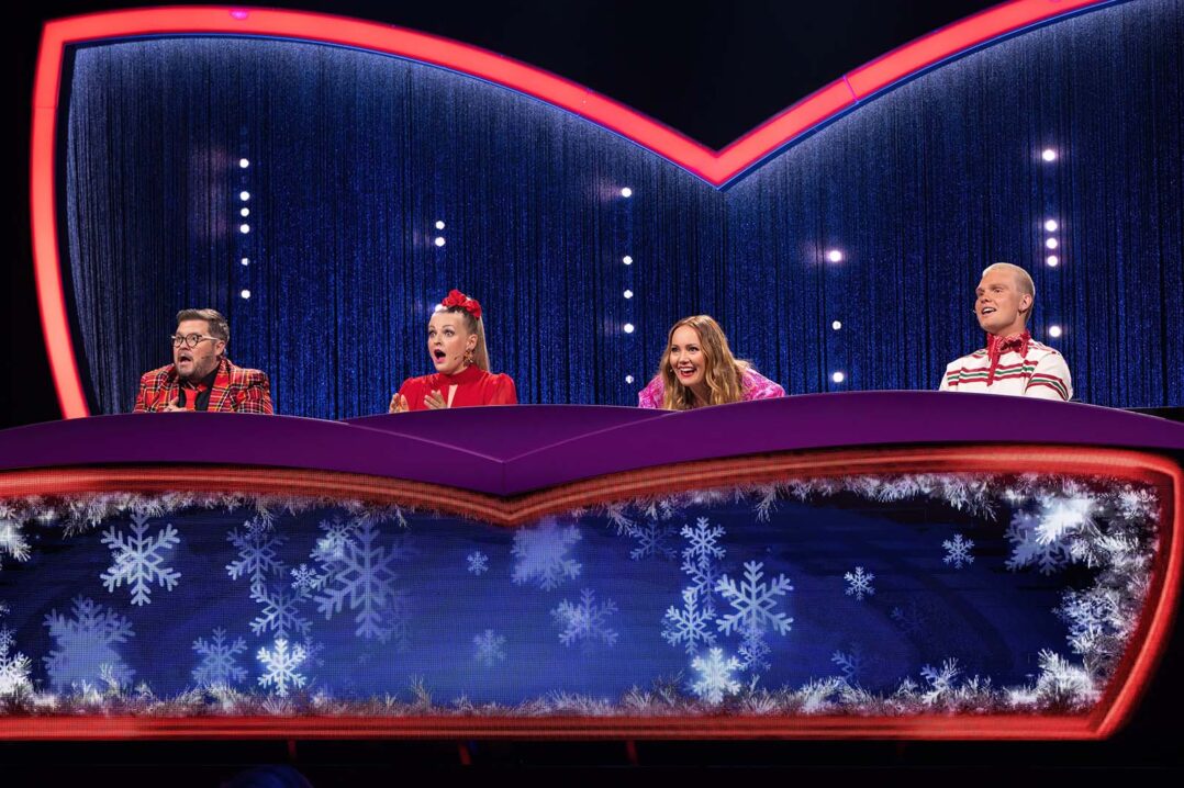 Masked Singer etsivät istuvat pöydän takana